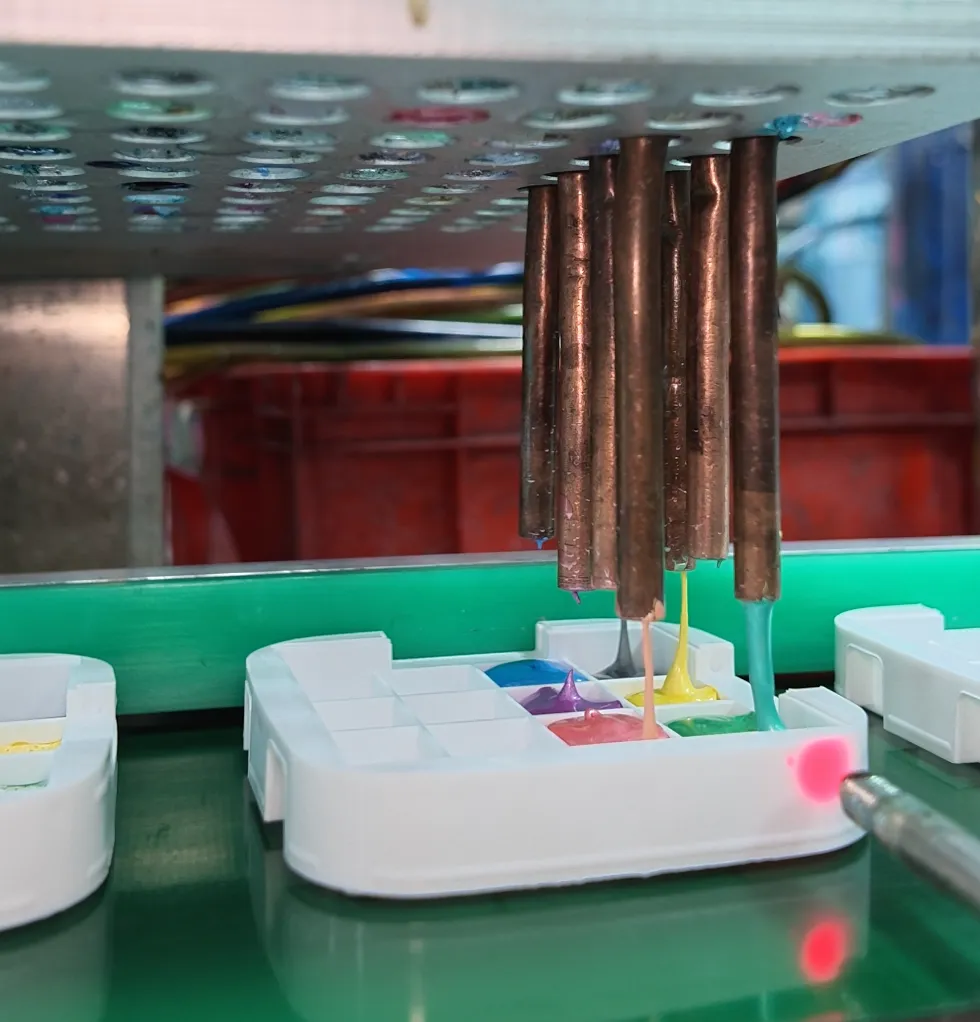 Automated watercolor factory production line dispensing semi-moist watercolor cakes